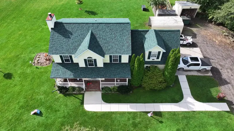 Aerial view of a completed Owens Corning shingle roof on a two-story home in Livingston County, Michigan