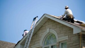 two workers working on a roof