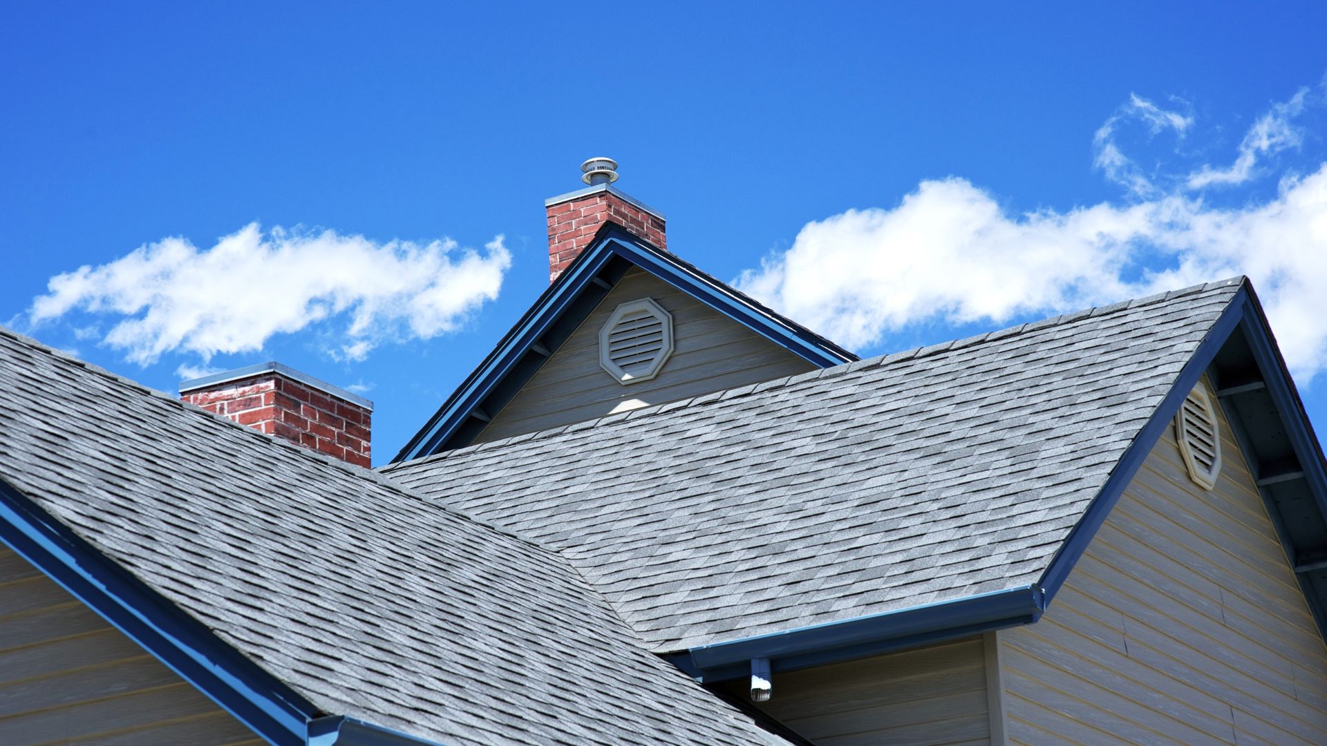 a house roof with a blue sky backdrop