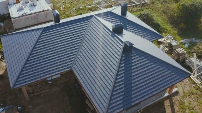 Aerial view of a house with a dark-colored roof