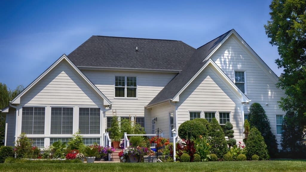A two-story white house with a dark roof